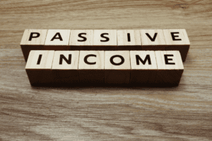 Image of ‘passive income’ written on wooden block to symbolise earning passive income in Singapore